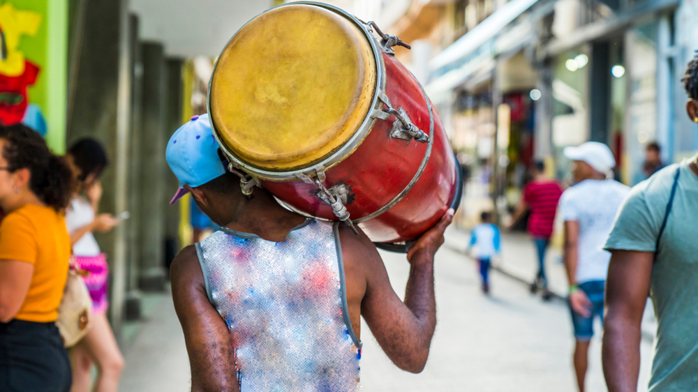 Havana,,Cuba.,Man,Walks,Down,The,Street,Carrying,His,Drum